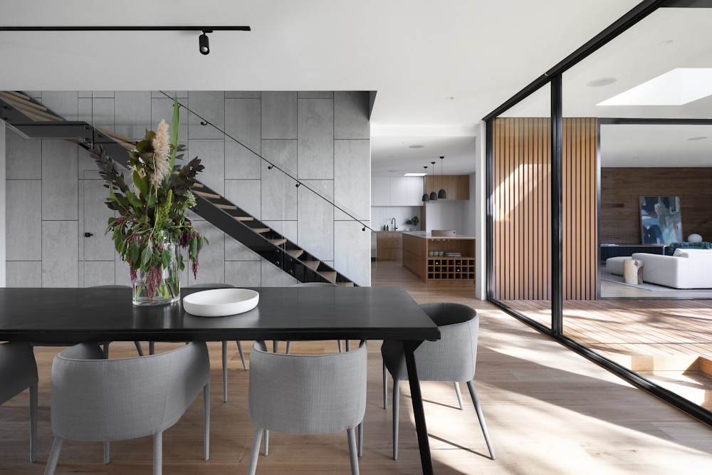 Open-plan residential space with a sculptural staircase and garden views
