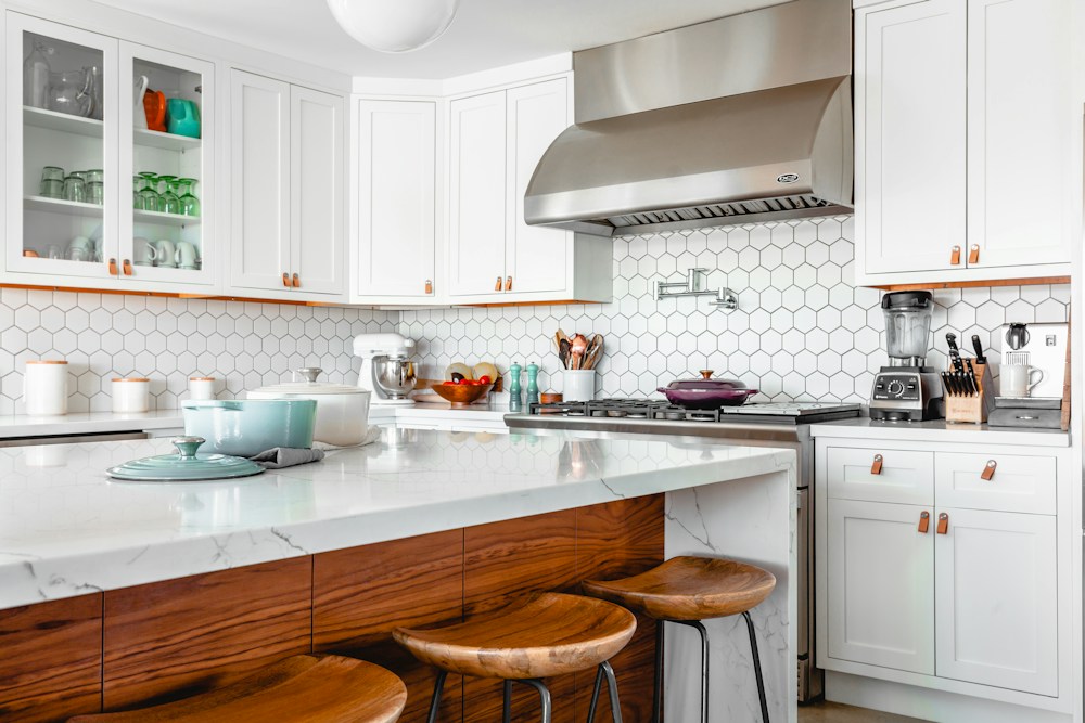 White and timber kitchen with a spacious island and breakfast stools